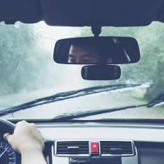 Man driving car in heavy rainfall