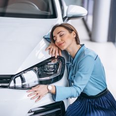 Beautiful woman hugging a car