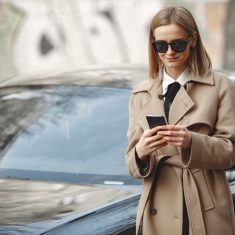 Elegant woman in a brown coat in a spring city