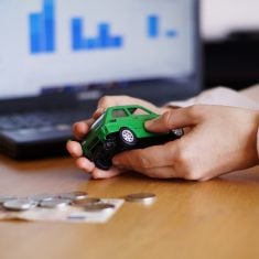 Closeup shot of a person thinking of buying a new car or selling a vehicle