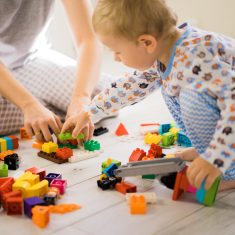 boy with mom playing in colorful building kit