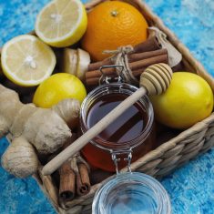 Background with ingredients: fresh ginger ,lemon,cinnamon sticks,honey,dried cloves for making immunity boosting healthy vitamin drink
