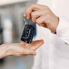 Stylish and elegant couple in a car salon
