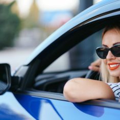 Woman in sunglasses driving a car