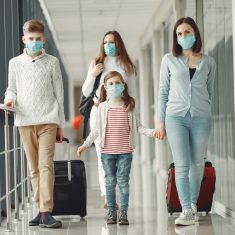 People in airport are wearing masks to protect themselves from v