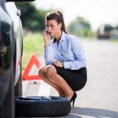 20660098 - photo of businesswoman with flat tire