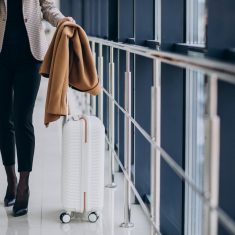 Business woman in terminal with travel bag