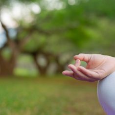 Women are playing yoga at the park. Exercising.
